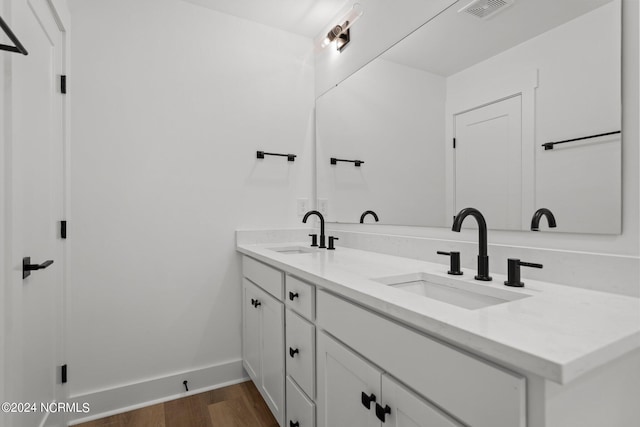 bathroom featuring hardwood / wood-style flooring and vanity