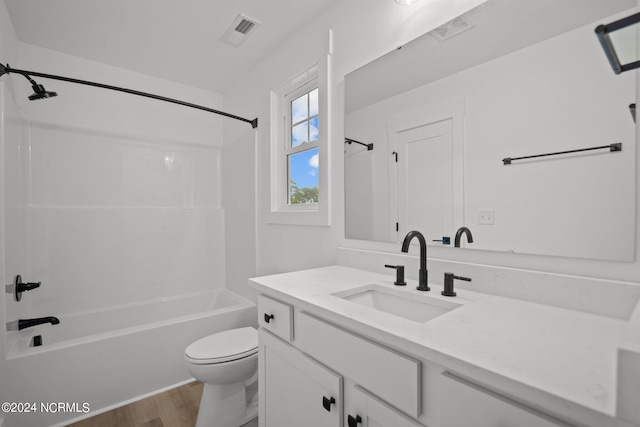 full bathroom with shower / washtub combination, wood-type flooring, vanity, and toilet