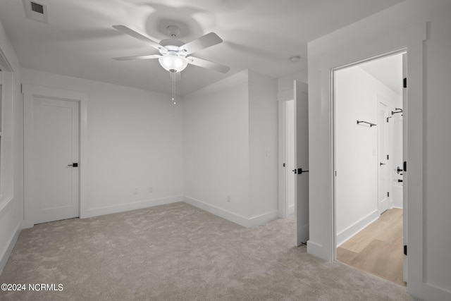 carpeted empty room with ceiling fan