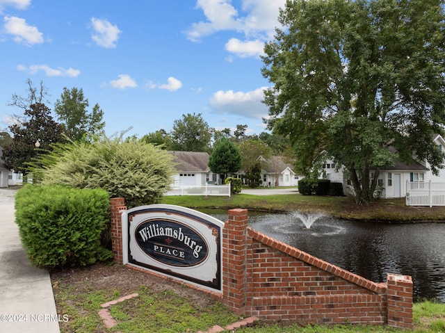 community / neighborhood sign featuring a water view