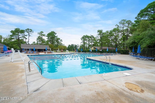 view of swimming pool with a patio