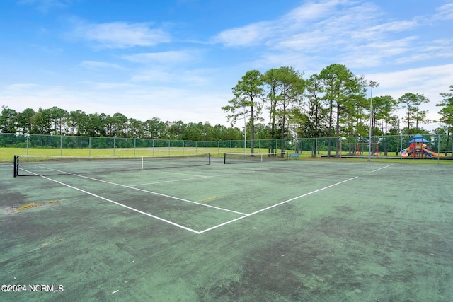 view of sport court with a playground