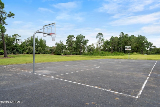 view of basketball court with a lawn