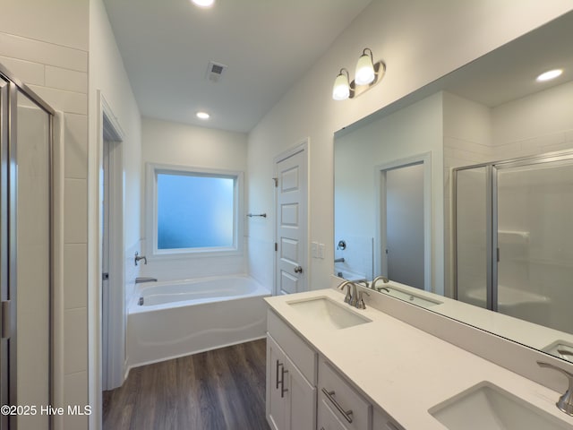 bathroom with vanity, separate shower and tub, and hardwood / wood-style floors