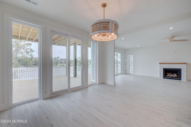 unfurnished living room featuring light wood-type flooring and ceiling fan