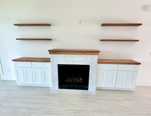 13 E Cannon Cv, Hampstead, NC 28443 - interior details featuring baseboards, wood finished floors, and a tile fireplace