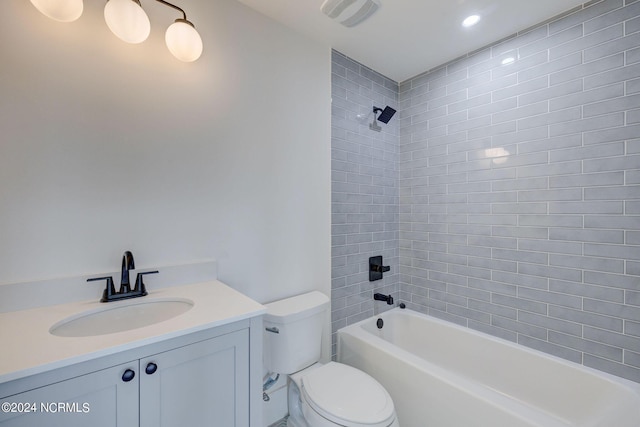 full bathroom featuring vanity, toilet, and tiled shower / bath