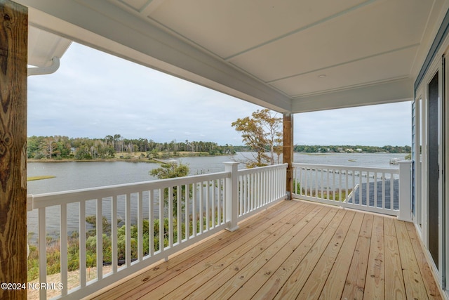 wooden terrace featuring a water view