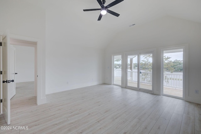 spare room with ceiling fan, high vaulted ceiling, and light hardwood / wood-style floors