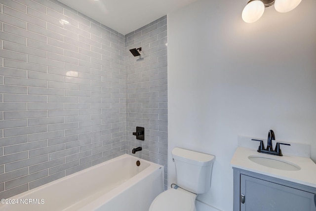 full bathroom featuring vanity, toilet, and tiled shower / bath