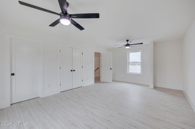 unfurnished bedroom with light hardwood / wood-style floors and ceiling fan