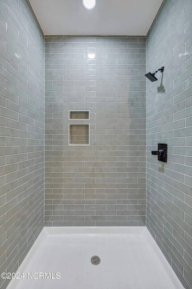 bathroom with a tile shower