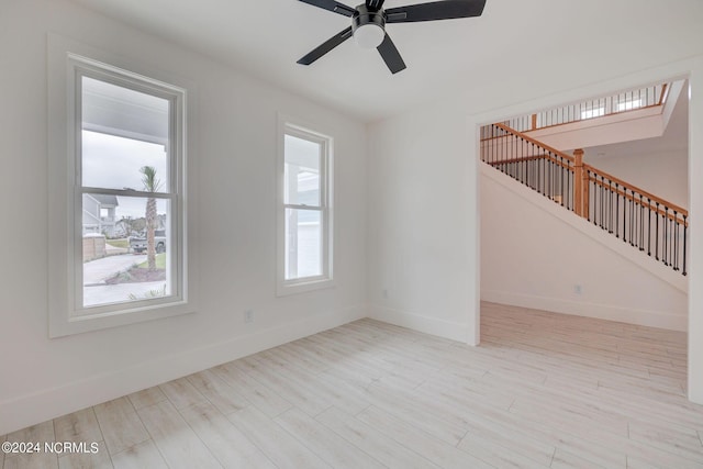 unfurnished room featuring light hardwood / wood-style floors and ceiling fan