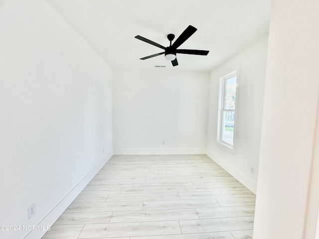 spare room featuring ceiling fan and light hardwood / wood-style flooring