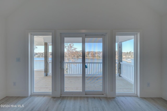 entryway with a water view and light wood-type flooring