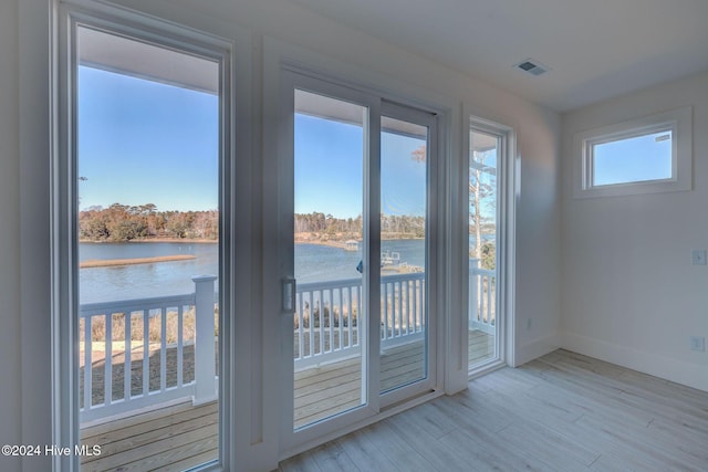 13 E Cannon Cv, Hampstead, NC 28443 - entryway featuring visible vents, baseboards, a water view, and wood finished floors