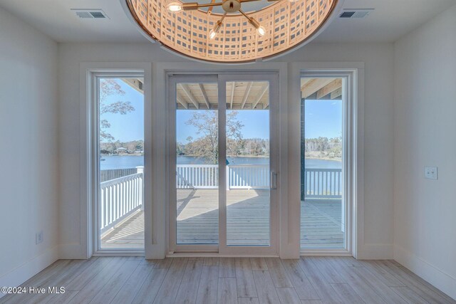 entryway featuring a water view and light hardwood / wood-style flooring