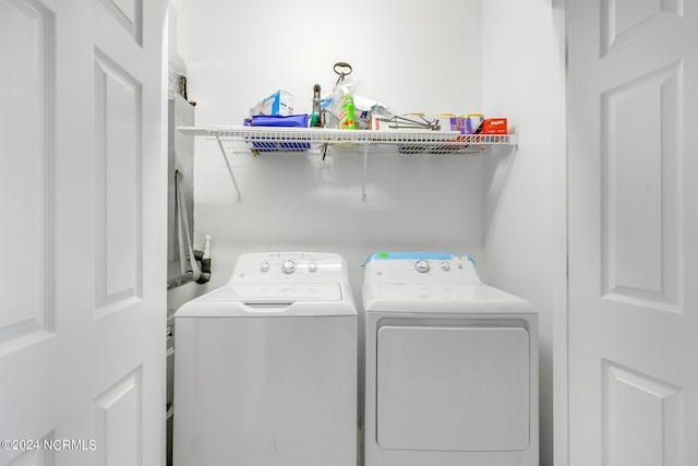 clothes washing area featuring laundry area and washer and clothes dryer