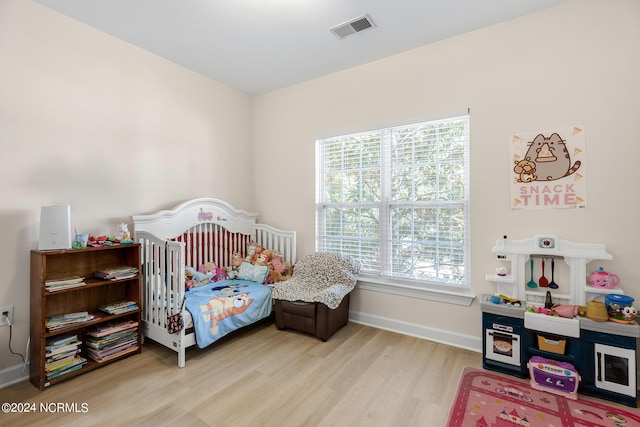 bedroom featuring light wood-type flooring and multiple windows