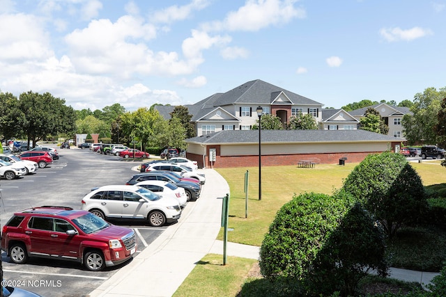 view of parking with a lawn