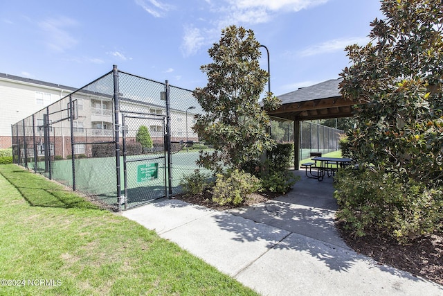 exterior space featuring a yard, fence, and a gate