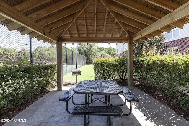 view of patio / terrace with outdoor dining space, fence, and a gazebo