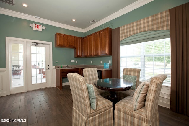 dining space featuring ornamental molding and dark hardwood / wood-style flooring