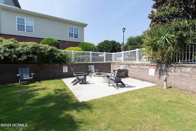 view of yard featuring an outdoor fire pit and a patio area