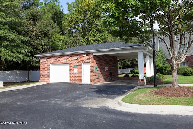 garage with a yard and a carport