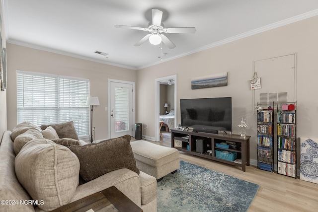 living room with ornamental molding, ceiling fan, and light hardwood / wood-style floors