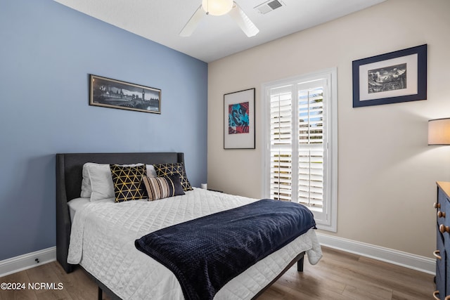 bedroom with hardwood / wood-style floors and ceiling fan