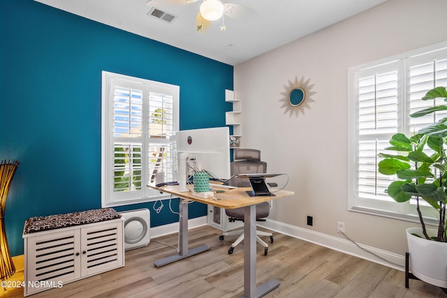 home office featuring light wood-type flooring and ceiling fan