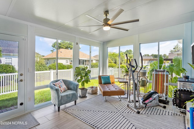 sunroom with ceiling fan and a healthy amount of sunlight