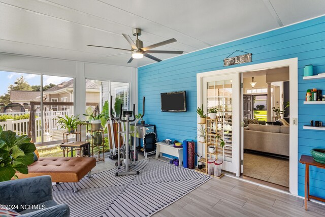 sunroom featuring ceiling fan