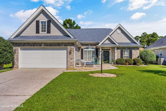 view of front of house featuring a front lawn and a garage