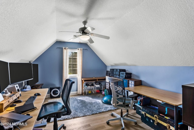 office space with lofted ceiling, a textured ceiling, ceiling fan, and light hardwood / wood-style floors