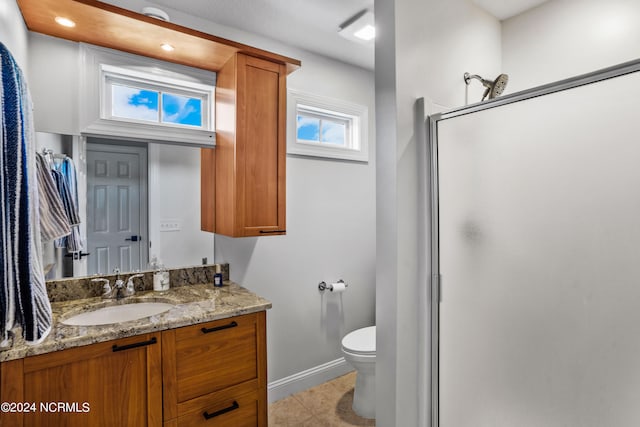 bathroom featuring vanity, toilet, tile patterned flooring, and an enclosed shower