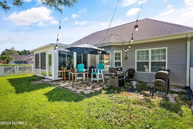 rear view of house featuring a patio and a yard