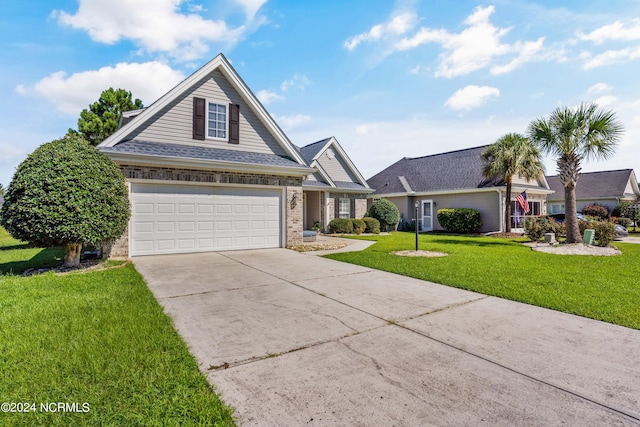 view of front of property featuring a front lawn and a garage