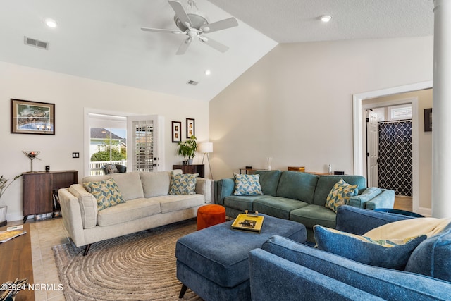 living room with ceiling fan, high vaulted ceiling, and light tile patterned flooring