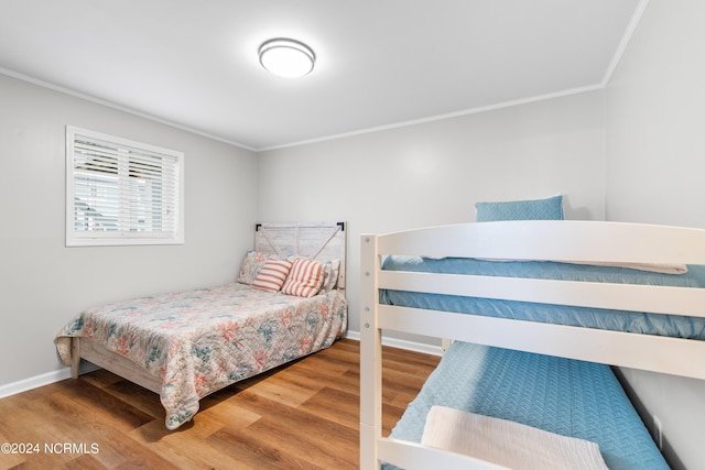 bedroom featuring crown molding and hardwood / wood-style floors