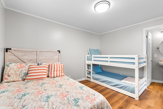 bedroom with wood-type flooring and crown molding