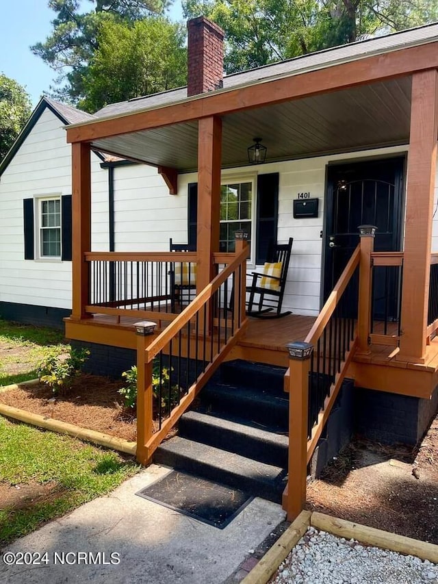 doorway to property with covered porch