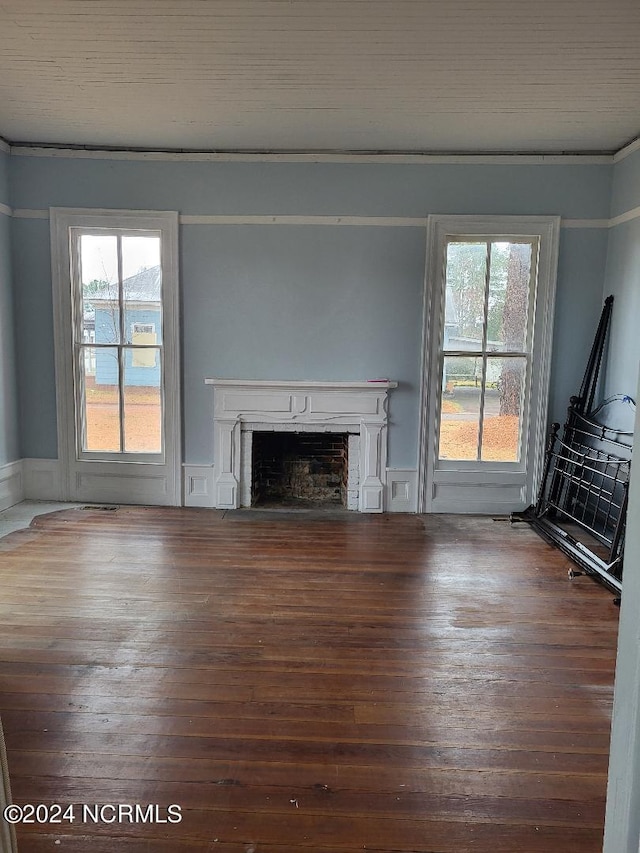 unfurnished living room featuring wood-type flooring and plenty of natural light