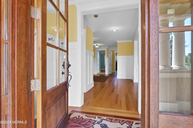 foyer entrance featuring crown molding and wood-type flooring