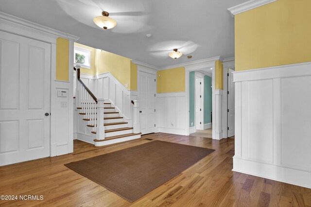 entrance foyer with light hardwood / wood-style flooring and ornamental molding