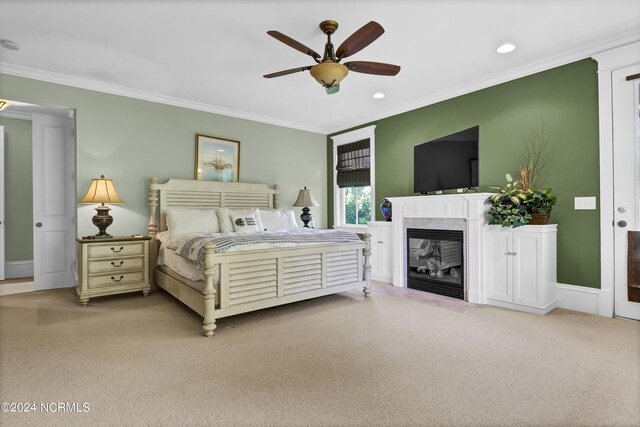 carpeted bedroom featuring ceiling fan and ornamental molding