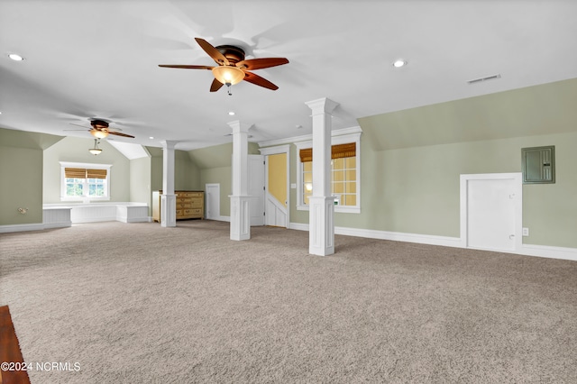 interior space featuring ceiling fan, ornate columns, lofted ceiling, and light carpet