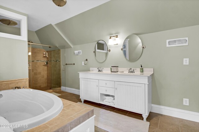 bathroom featuring dual vanity, tile patterned flooring, and independent shower and bath