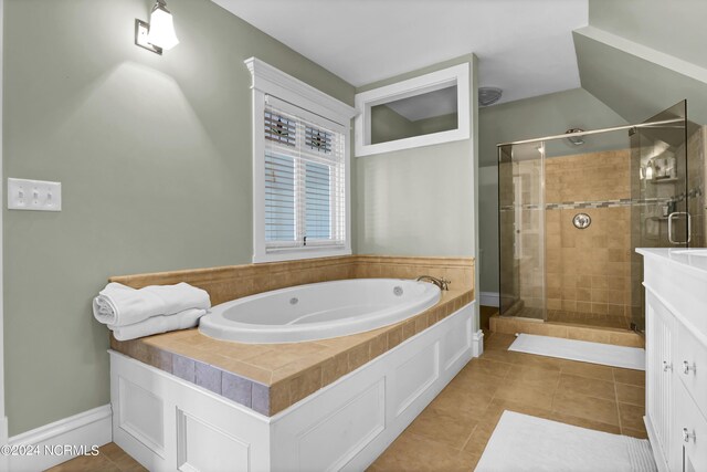 bathroom with vanity, plus walk in shower, and tile patterned flooring